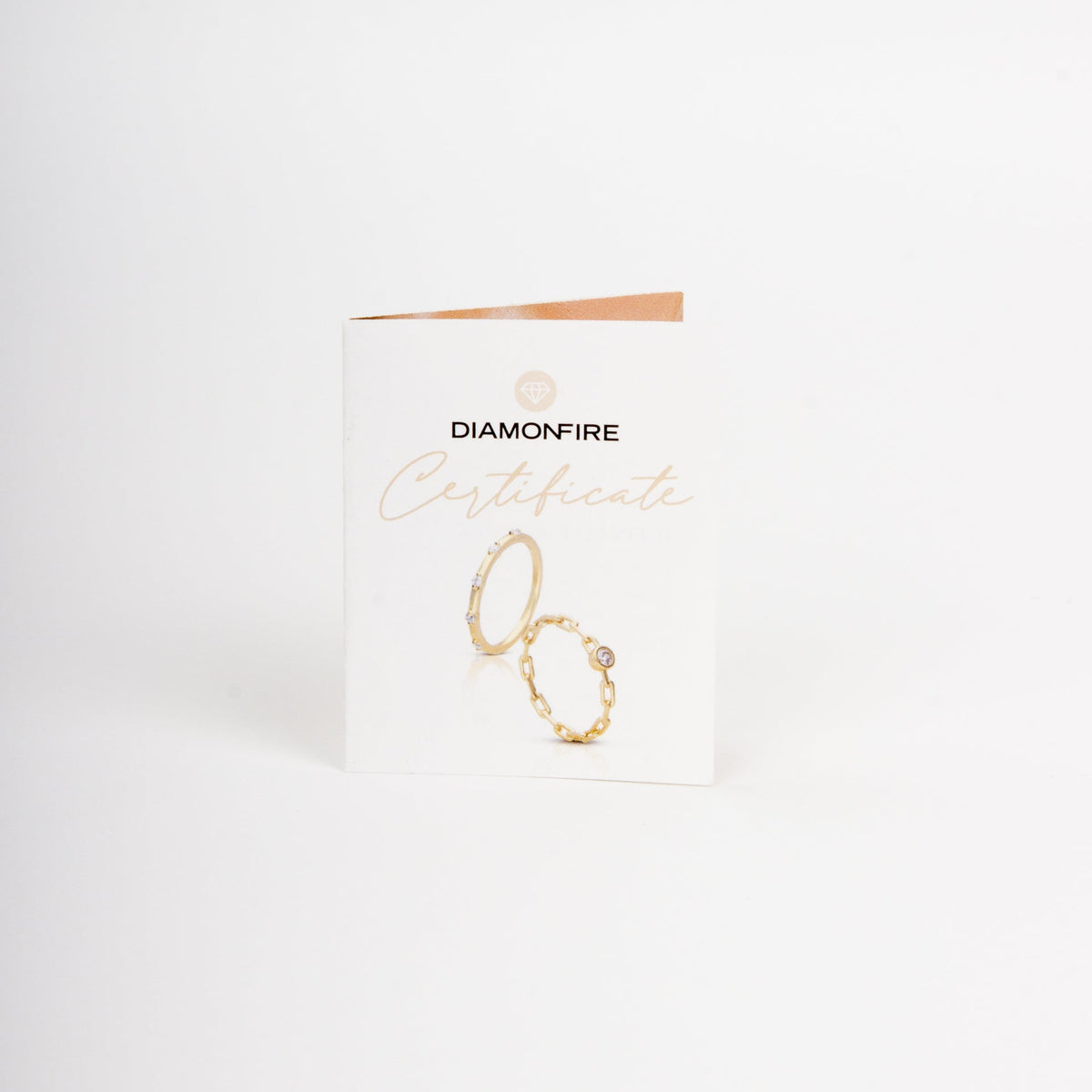 Gold ring on a Diamonfire branded card against a white background