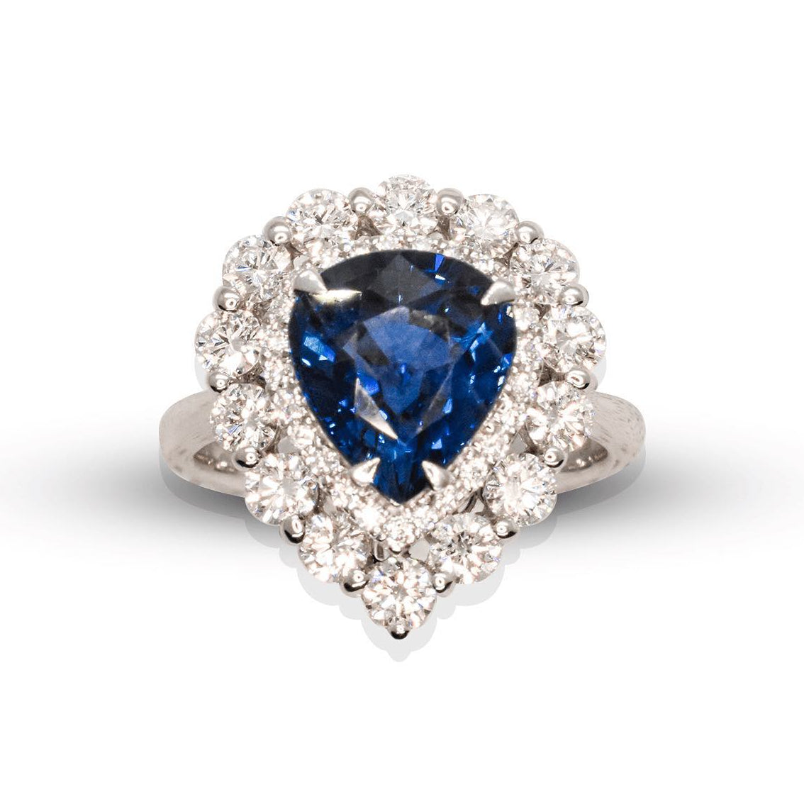 Ring with a blue gemstone and diamond-studded halo on a white background