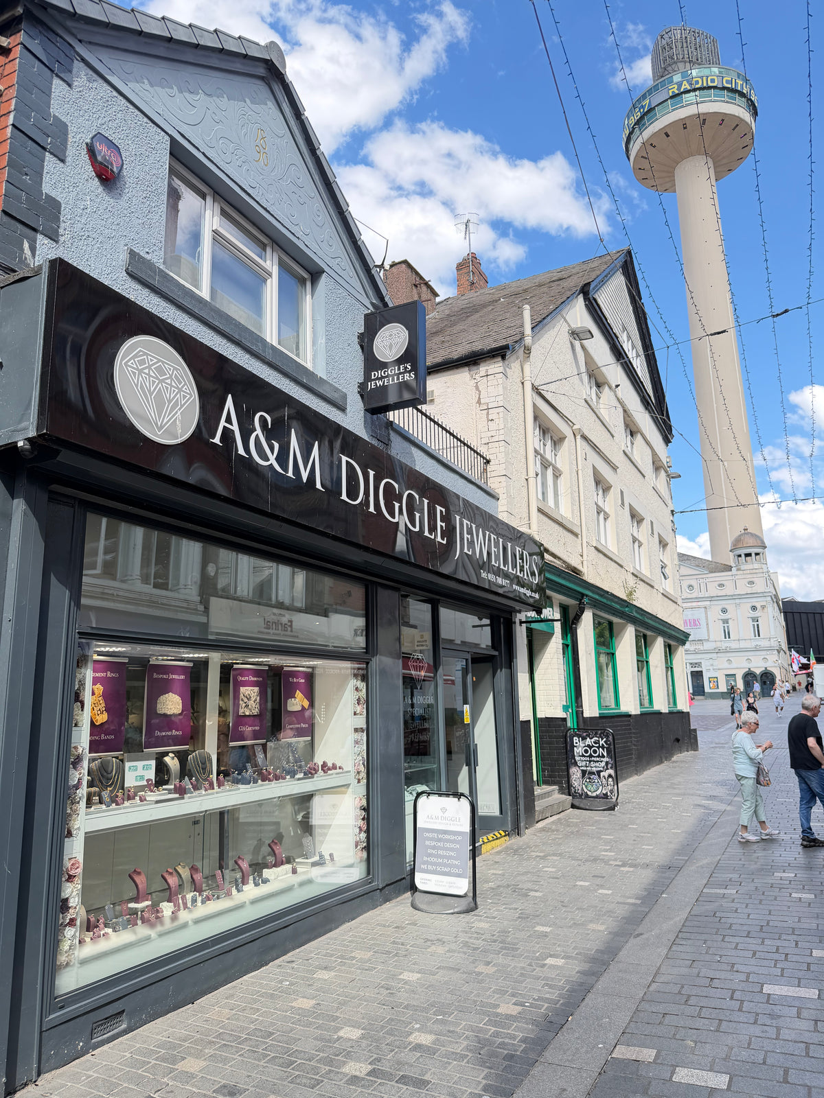 A&M Diggle Jewellers store front with a tall building in the background
