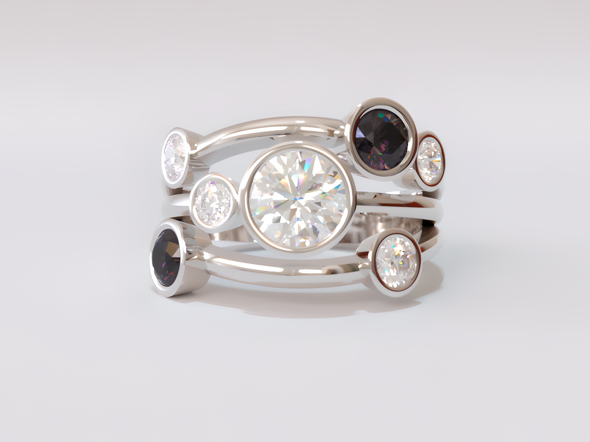 A silver-toned multi-band ring set featuring a large round clear center stone, smaller clear stones, and two dark oval gemstones, photographed on a clean light gray background.