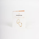 Gold ring on a Diamonfire branded card against a white background