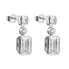 Pair of silver earrings with rectangular gemstones on a white background