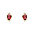 Gold earrings with red gemstones on a white background
