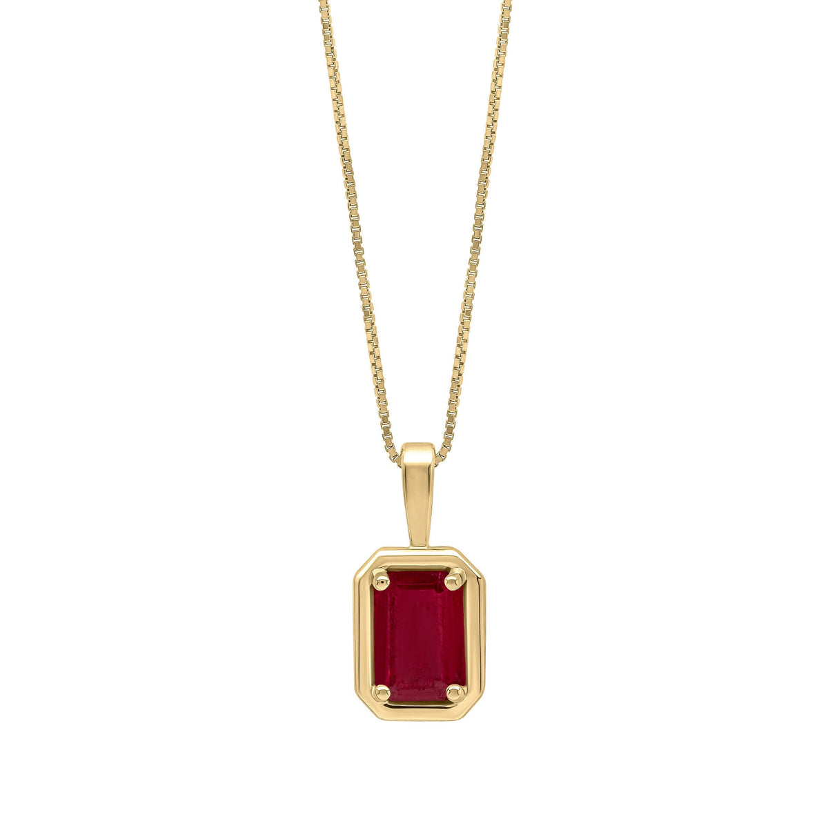 Gold pendant with a red gemstone on a white background