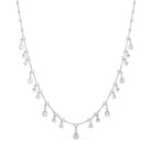 Silver necklace with teardrop-shaped crystals on a white background