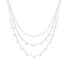 Layered silver necklace with star-shaped pendants on a white background