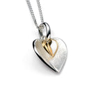 Heart-shaped silver and gold pendant on a white background