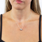 Necklace with a pendant worn by a person