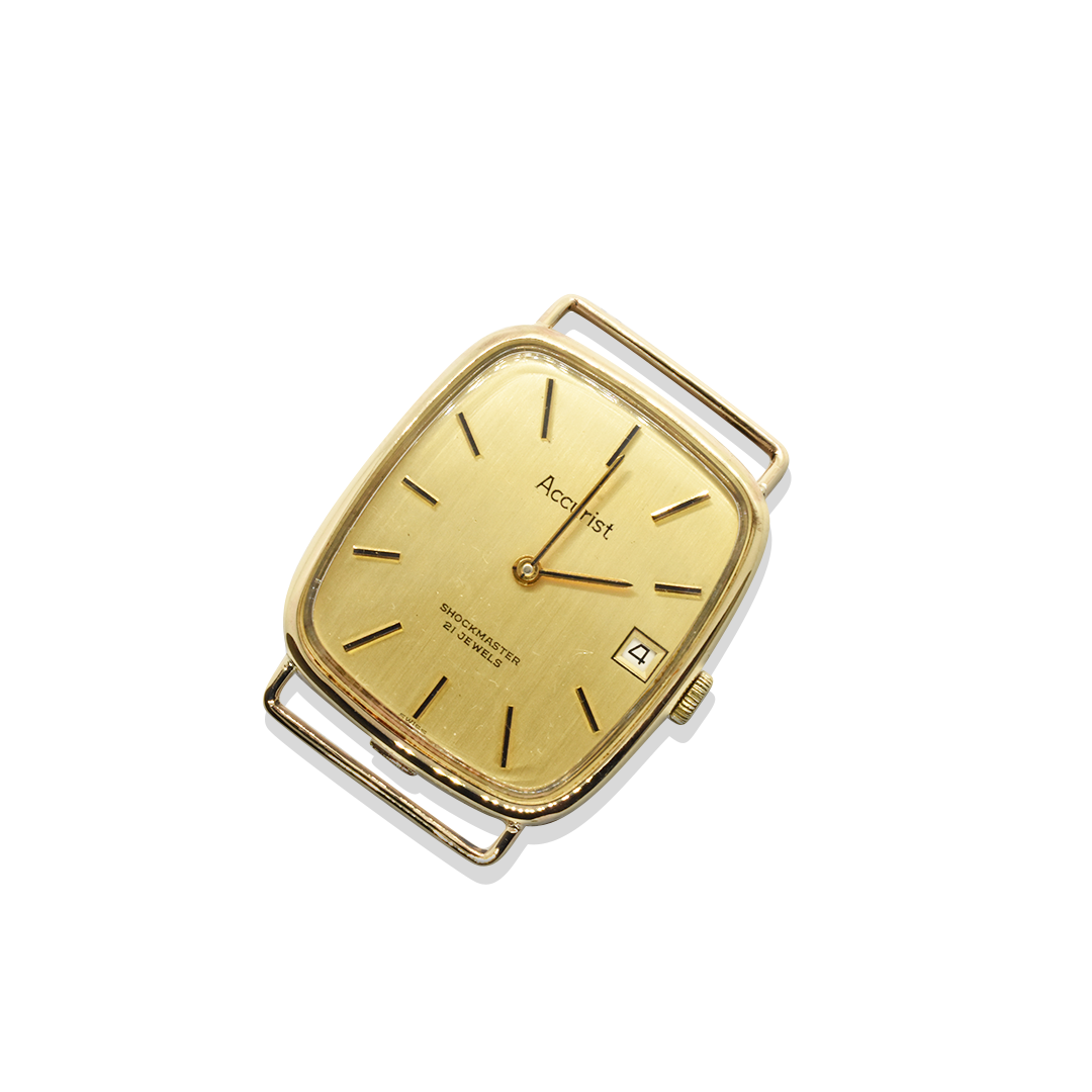 Gold wristwatch with a visible brand name on a white background